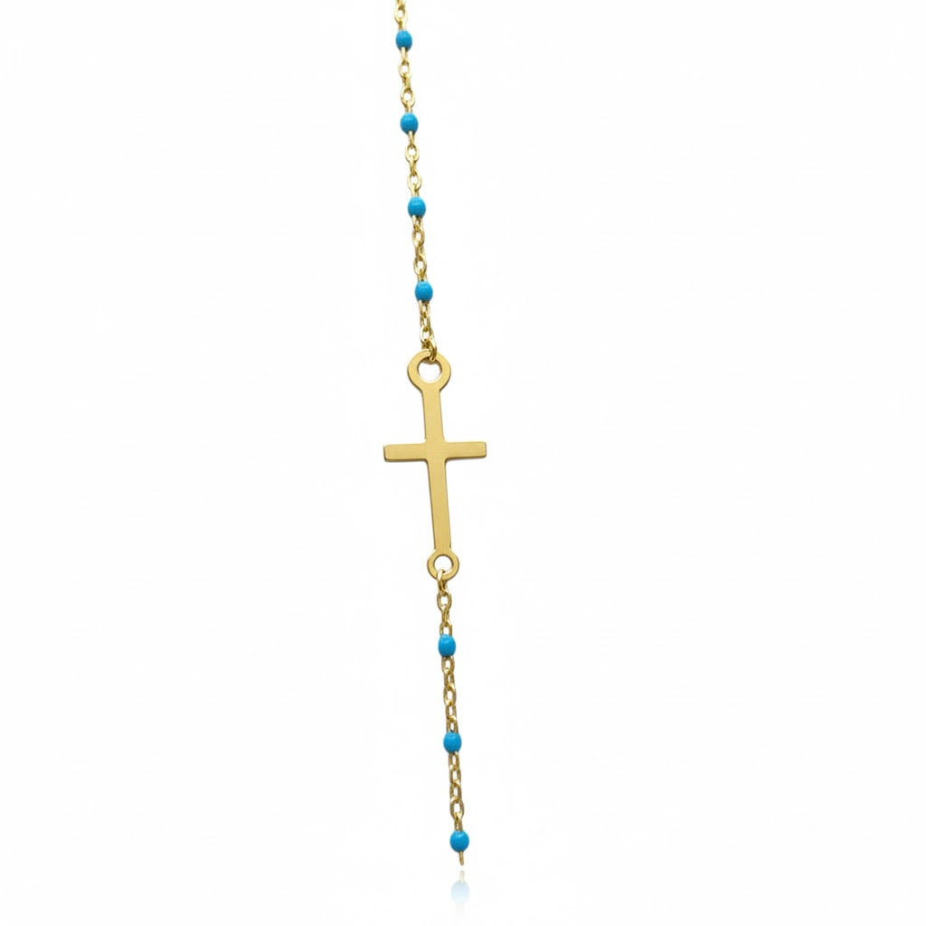 Pulsera cruz con bolitas azules en oro 10K, diseño elegante y delicado, de la joyería ROMA.