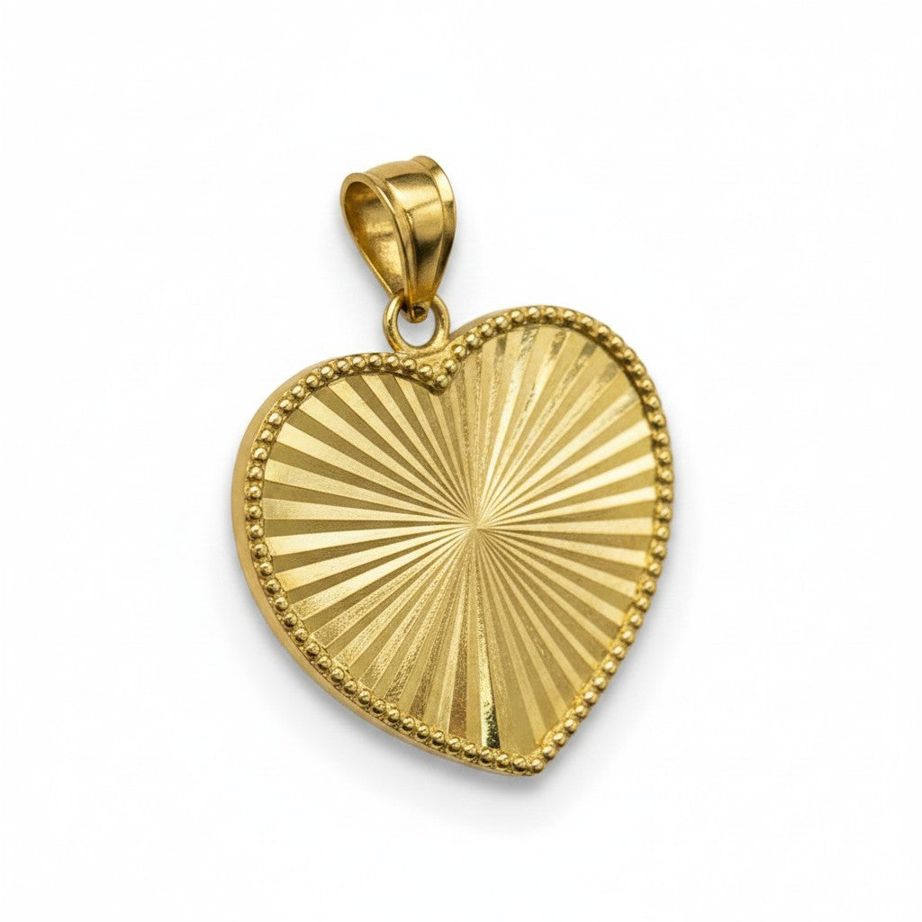 Dije corazón facetado en oro 10K de Joyería ROMA, con acabado brillante y diseño elegante.