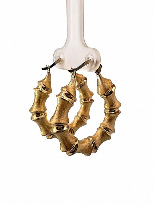 Joyería ROMA 10K yellow gold bamboo hoop earrings with a brushed texture and polished accents.